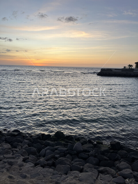 Sunset on the rock coast of Jeddah, the landscape in the Corniche on the Red Sea coast, famous tourist attractions and places, the waterfront in the Kingdom of Saudi Arabia, the quiet natural atmosphere
