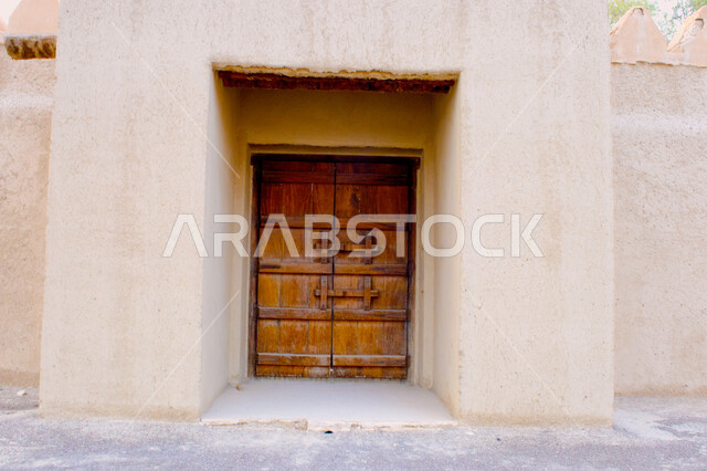 Historical villages and cities, ancient Arab architectural design for ancient antique wooden doors, a wooden door for a mud house, heritage places in the Kingdom of Saudi Arabia