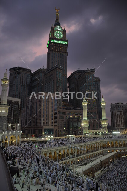 Landmarks and purposes for performing worship and getting closer to God Almighty, sacred Islamic religious landmarks in the Kingdom of Saudi Arabia, architectural engineering art for building towers and skyscrapers, a close-up of the Royal Clock Tower building in Mecca, performing rituals at night.