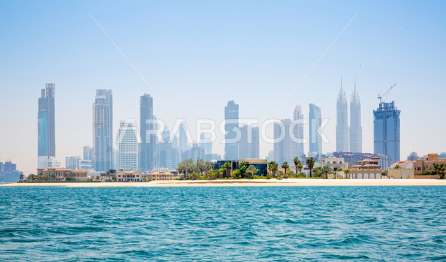 The waterfront overlooking the coast of the Arabian Gulf, the skyline of Dubai, the economic renaissance and urban development of towers and skyscrapers in the United Arab Emirates, architectural art in the modern and advanced style of residential buildings, famous tourist attractions
