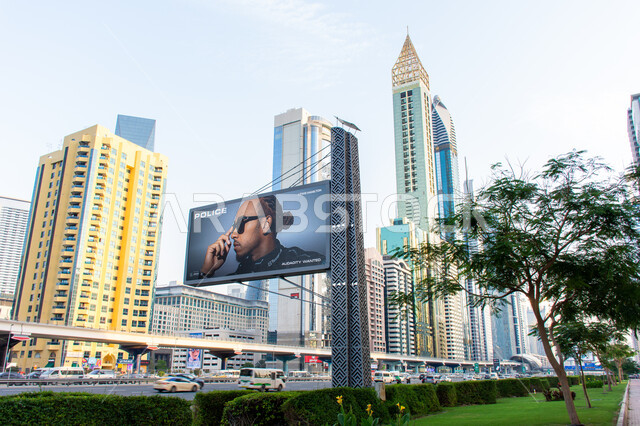Marketing and advertising concept, billboard on Sheikh Zayed Road in Dubai, architectural art of towers and skyscrapers, traffic movement on roads and streets of UAE