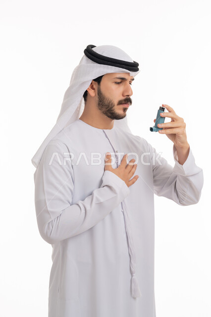 Inhalers for patients, respiratory problems, portrait of an Emirati Gulf Arab man wearing a kandora and ghutra, holding an asthma nebulizer in his hand, maintaining a regular airway, white background
