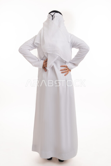 Fatigue, exhaustion, and a feeling of illness, the need for treatment, spine and back pain, a portrait from the back of an Arab Gulf Emirati man wearing a kandora and a ghutra, placing his hand on his back, feeling of physical pain and pain, full-length body image, white background.