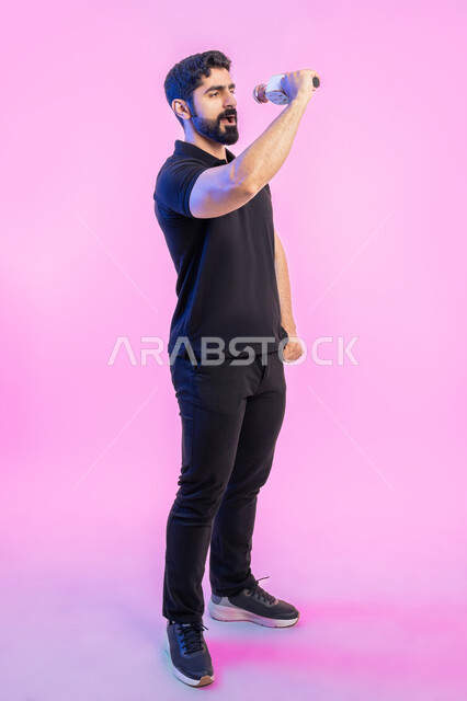 Recording a singing audio clip, enjoying the performance of vocal talents, a portrait of a young Arab Gulf Emirati man wearing a casual outfit holding a microphone in his hand, gestures and expressions of merging and interacting with the music, presenting theatrical performances, full-length body portrait, pink background.