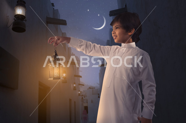 A wonderful Ramadan atmosphere for a beautiful young Saudi Gulf boy, holding a colorful lantern in his hand with different facial and hands gestures, side view of a Saudi Gulf child wearing elegant traditional Saudi dress, Islamic religious holidays and o