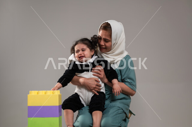 Aversion and difficulty in dealing, providing entertainment services for children, a Filipina home nanny who takes care of the children, learning concentration and innovation skills, expressions of crying and not wanting to play, carrying a Saudi Gulf Arab girl, attracting foreign clients from abroad, gray background