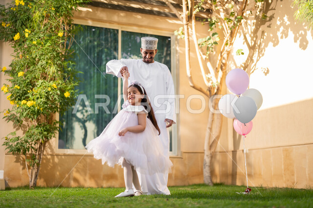 Taking a walk and spending happy times in private restrooms, a portrait of an Arab Gulf Omani family walking around inside a residential compound, playing and spending fun times and happy events inside the residential neighborhood, family housing in the Sultanate of Oman, luxury villas and apartments.