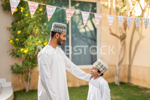 Taking a walk and spending happy times in private restrooms, a portrait of an Arab Gulf Omani family walking around inside a residential compound, playing and spending fun times and happy events inside the residential neighborhood, family housing in the Sultanate of Oman, luxury villas and apartments.