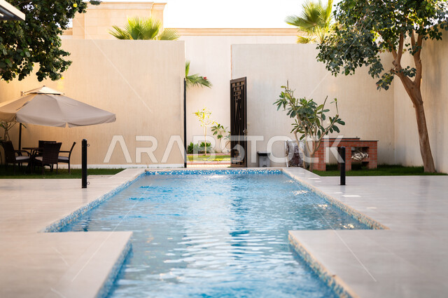 Modern architectural art for residential apartments and villas, distinctive modern designs for the swimming pool, interest in planting trees and green plants in the garden of a luxury residential complex, distinctive tourist resorts.