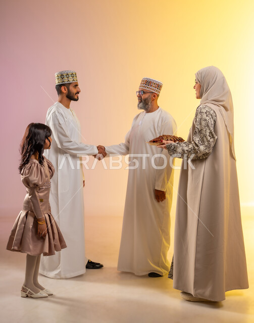 Greetings and handshakes between family members, an atmosphere of joy and joy at Eid, a portrait of an Arab Gulf Omani family celebrating Islamic holidays, rituals of celebrations and happy occasions, offering traditional sweets and delicious food, showing feelings of family affection and love, a colorful background