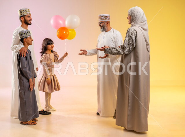 Celebrations, decorations and balloons, congratulations and greetings among family members, an atmosphere of joy and happiness on Eid, a portrait of an Arab Gulf Omani family celebrating Islamic holidays, providing traditional sweets and delicious food, showing feelings of family affection and love, a colorful background