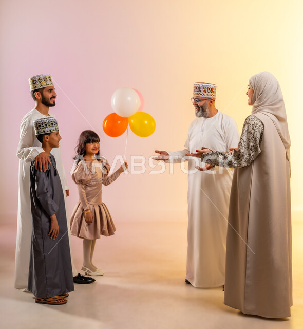 Decorations, balloons, celebrations, congratulations and greetings among family members, an atmosphere of joy and happiness on Eid, a portrait of an Arab Gulf-Omani family celebrating Islamic holidays, providing traditional sweets and delicious food, showing feelings of family affection and love, a colorful background