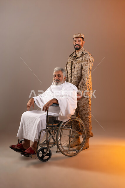 Helping pilgrims and Umrah pilgrims coming to Mecca to perform religious rituals, the gallantry of security personnel serving the guests of God, a portrait of a Saudi Gulf Arab man wearing a military uniform pulling a wheelchair for an elderly man wearing Ihram clothes with special needs, orange background.