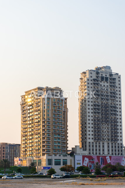 Architectural engineering art of high-rise residential and commercial buildings and facilities in the Creek area in the Emirate of Dubai, famous landmarks and tourist places in the United Arab Emirates, traffic movement in the streets and paved asphalt roads