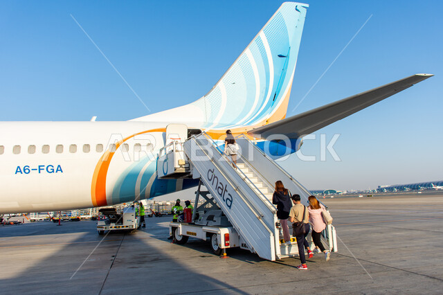 Passengers preparing to board the plane, means of transportation and air transportation, the most important air hub in the Middle East, Emirati airlines and companies, tourism in the United Arab Emirates, a fleet of planes inside Dubai International Airport, the landing and take-off runway
