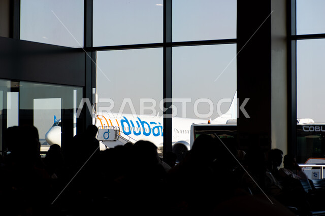 The most important air hub in the Middle East, passengers sitting in the waiting hall at Dubai Airport, tourism and travel in the United Arab Emirates