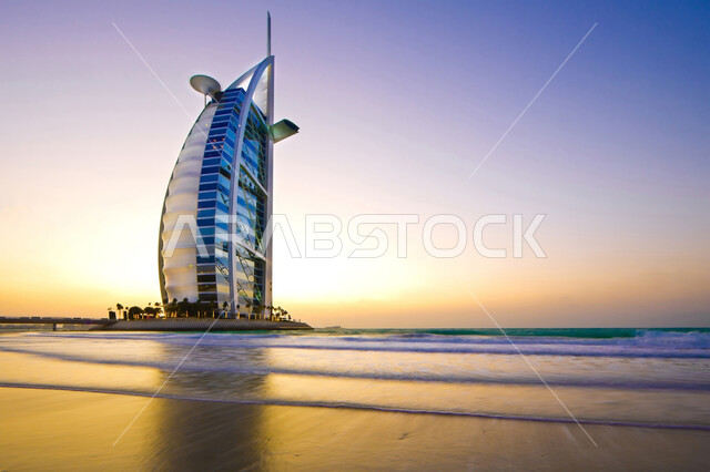 Architectural arts and designs for facilities and buildings in the Emirate of Dubai during the day, the development and architectural progress of towers and skyscrapers in the United Arab Emirates, Burj Al Arab in Jumeirah, landmarks and famous tourist places.