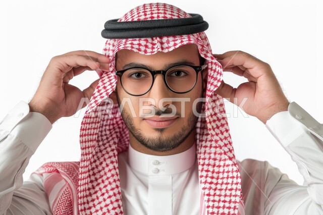 Expressions of wit and intelligence, a close-up portrait of a Saudi Gulf Arab man wearing a shemagh, traditional dress, and medical glasses, looking at the camera with gestures of joy and pleasure, the concept of precision and focus, white background
