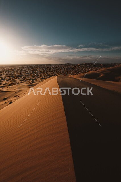 Terrain, heights and mountain peaks in the prairies, sand formations and formations in the desert of the Kingdom of Saudi Arabia, plateaus and hills of soft golden sand, sunset over the desert regions and the natural desert environment, nature background.