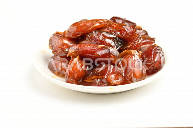 A plate of dates filled with high nutritional values, summer fruit, the fruit of palm trees