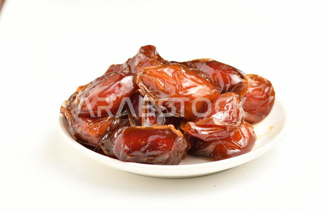 A plate of dates filled with high nutritional values, summer fruit, the fruit of palm trees