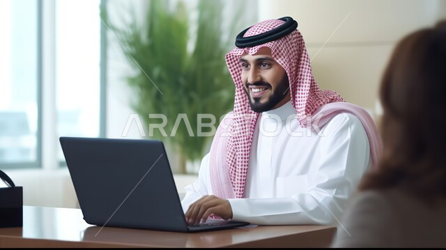 Integrating work with technology and technology, a Saudi Gulf Arab man wearing a traditional thobe and shemagh sits in his office and browses business management applications on his laptop, completing required office tasks, Saudi professions and jobs in the Kingdom