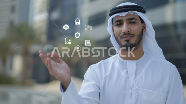 النظر الى الكاميرا بتعابير السرور والثقة بالنفس، صورة مقربة لرجل أعمال عربي خليجي إماراتي يرتدي الكندورة والغترة يرفع يده الى الاعلى، دمج التقنية والتكنولوجيا مع الحياة العملية، أيقونات مالية وتجارية هولوجرامية ثري دي 