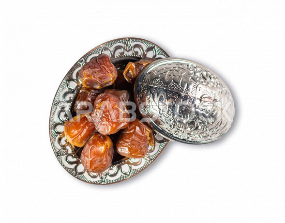 Portrait of a group of delicious dates in silver hospitality utensils, a healthy food item in the holy month of Ramadan, white background