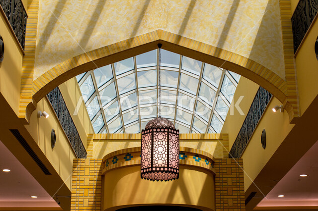 التراث العربي الشرقي الأصيل، مول ابن بطوطة في دبي بالإمارات العربية المتحدة، الأماكن و المعالم السياحية المشهورة، تصاميم وديكورات داخلية، إضاءة وزينة واكسسوارات، صورة مقربة فانوس رمضاني معلق في السقف، مصباح معدني تقليدي