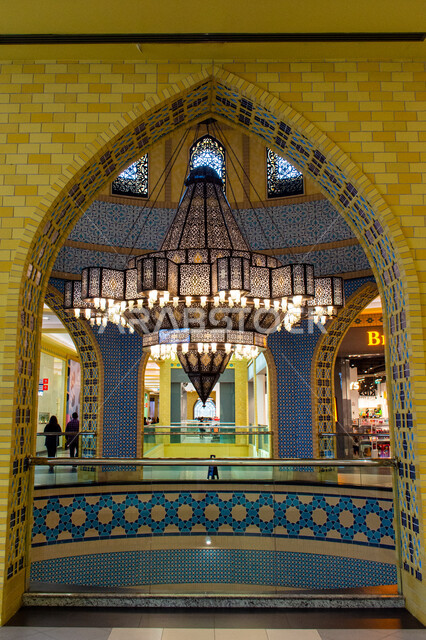 Luxurious interior designs and decorations, lighting, decorations and accessories, a close-up of a giant chandelier hanging from the ceiling, authentic eastern Arab heritage, Ibn Battuta Mall in Dubai in the United Arab Emirates, famous places and tourist attractions.