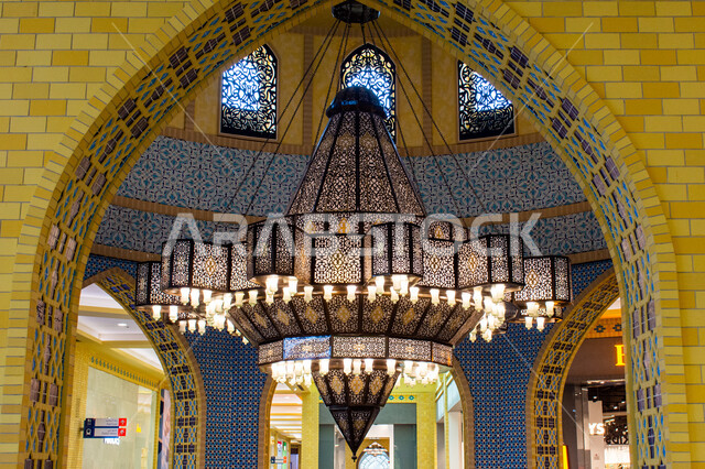 Luxurious interior designs and decorations, lighting, decorations and accessories, a close-up of a giant chandelier hanging from the ceiling, authentic eastern Arab heritage, Ibn Battuta Mall in Dubai in the United Arab Emirates, famous places and tourist attractions.