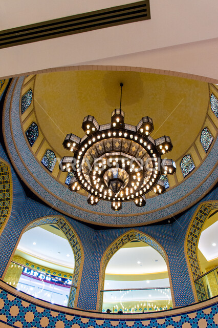 Luxurious interior designs and decorations, lighting, decorations and accessories, a close-up of a giant chandelier hanging from the ceiling, authentic eastern Arab heritage, Ibn Battuta Mall in Dubai in the United Arab Emirates, famous places and tourist attractions.