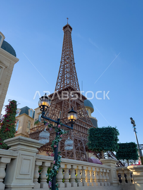 A model of the Eiffel Tower in the France Corner on Boulevard World in Riyadh, enjoying enjoyable experiences in the most prominent entertainment areas in the Kingdom of Saudi Arabia, activities and events in tourist places, modern-style buildings, a distinct French atmosphere.