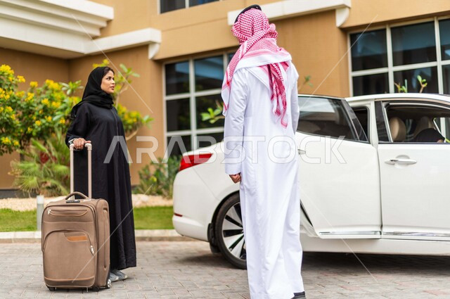 A Saudi Arabian Gulf man stops his car in front of the hotel, opens the car door for a veiled Saudi Arabian Gulf woman, carrying a travel bag in her hand, passenger delivery service, comfort and safety