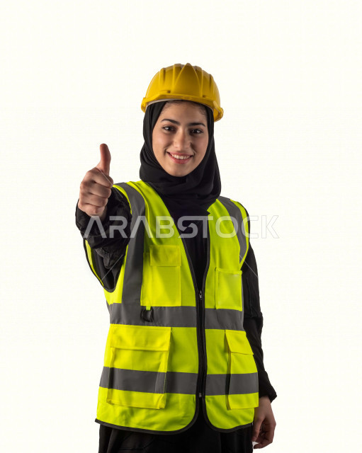 Portrait of a veiled Saudi Muslim architect, pointing with her finger with different facial and hands gestures, beautiful Muslim female engineer wearing safety suit at work, work helmet, business attire, construction project, white background