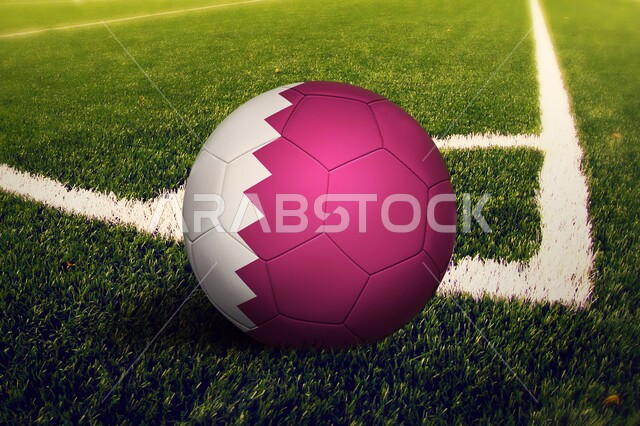 استضافة الاولومبيات الرياضية، بطولة كأس العالم 2022، مونديال قطر فيفا، صورة مقربة لكرة قدم بالوان العلم القطري على ارضية ملعب عشبية، مفهوم الاندية والتشجيع