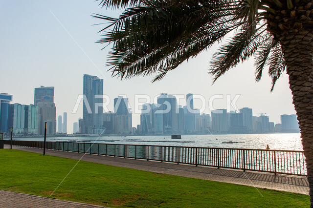 Architectural engineering art of buildings and structures overlooking the artificial sea, the growth and urban development of towers and skyscrapers in the United Arab Emirates, famous tourist attractions in Dubai, the waterfront on the coast of the Arabian Gulf
