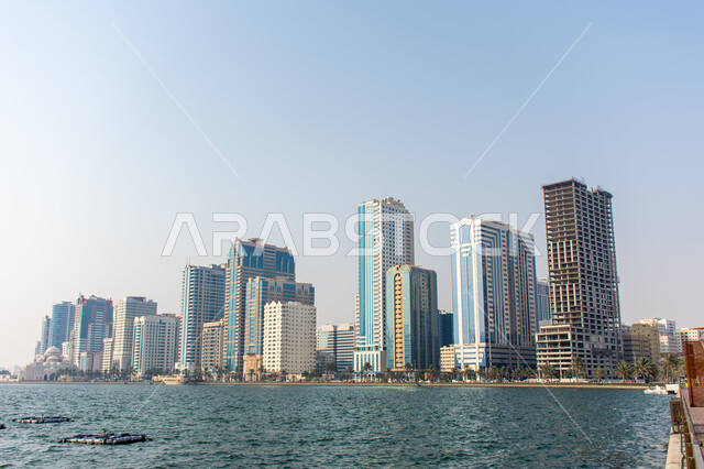Architectural engineering art of buildings and structures overlooking the artificial sea, the growth and urban development of towers and skyscrapers in the United Arab Emirates, famous tourist attractions in Dubai, the waterfront on the coast of the Arabian Gulf