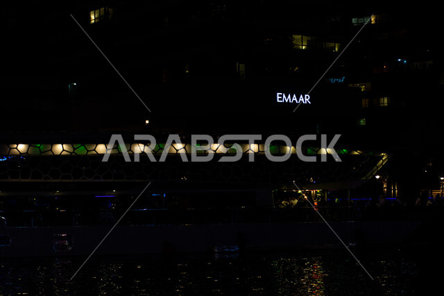 Modern architectural art of commercial facilities, illuminated sign of Emaar Properties building at night, leading real estate developer in Dubai, famous places and landmarks in UAE
