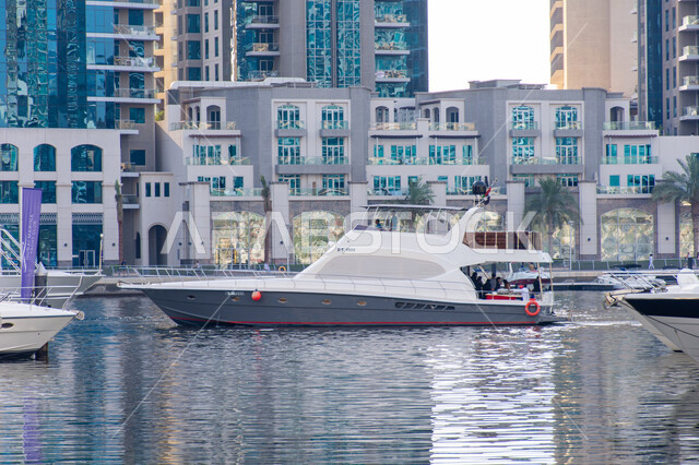 Modern architecture, excellent marine transportation in Palm Jumeirah, luxury boats in Dubai Marina, famous tourist places and landmarks in UAE, entertainment activities in summer season.