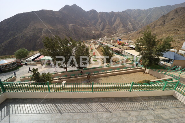 Spend quiet time in meditation and relaxation, the mountainous environment of the Abha region in Asir, a view of the green nature and beautiful parks and gardens, rocky mountain ranges and high peaks, terrain, trees and plants covering the mountain slopes, natural places for adventures and safari trips