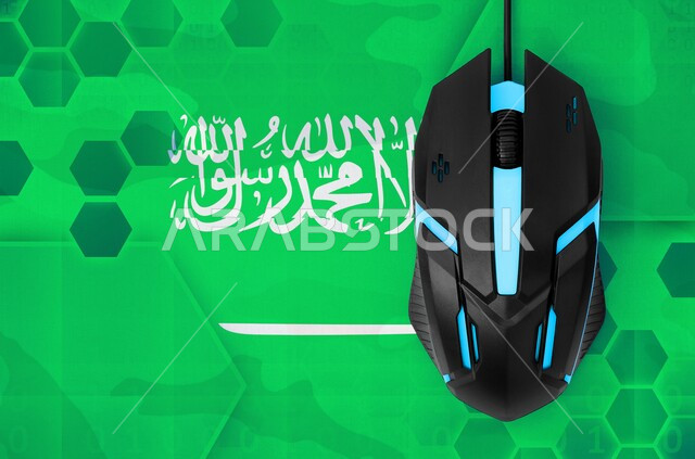 Participation in national holidays and events, a close-up image of the flag of the Kingdom of Saudi Arabia with a computer mouse above it, announcing the Saudi National Day, September 23, by providing technical services and technology
