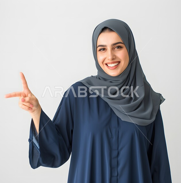 The concept of femininity, softness, and attention to external appearance, a veiled Saudi Arabian Gulf woman looking at the camera with gestures of self-confidence, sophisticated modern women’s clothing and veils, bright white teeth,