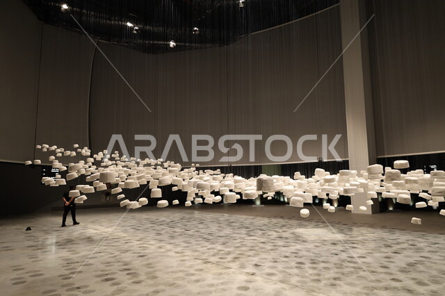 Pilgrims' Hall filled with white hats hanging from the ceiling, Biennale Museum of Islamic Arts in Jeddah, Saudi Arabia, attractions and tourist and visitor destinations to learn about the history of the Holy Land, famous cultural landmarks, distinctive religious artifacts and collectibles