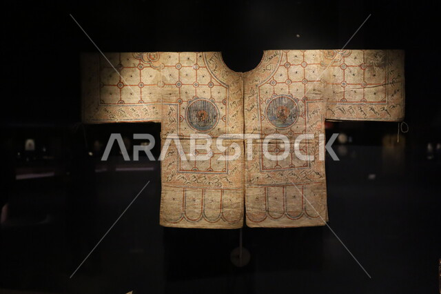 Display of the cursed talismanic shirt with the talisman and tattoo of Al-Ma'mun, the Biennale Museum of Islamic Arts in the Kingdom of Saudi Arabia, attractions and destinations for tourists and visitors to learn about the history of the Holy Land, famous cultural landmarks in the city of Jeddah, distinctive religious artifacts and collectibles