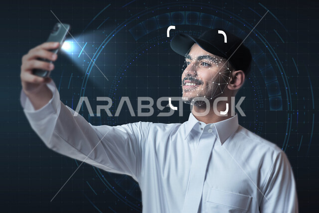 A close-up image of a smiling Saudi Arabian Gulf man using the fingerprint feature to identify the face on the phone using hologram technology, using the 3D hologram feature.