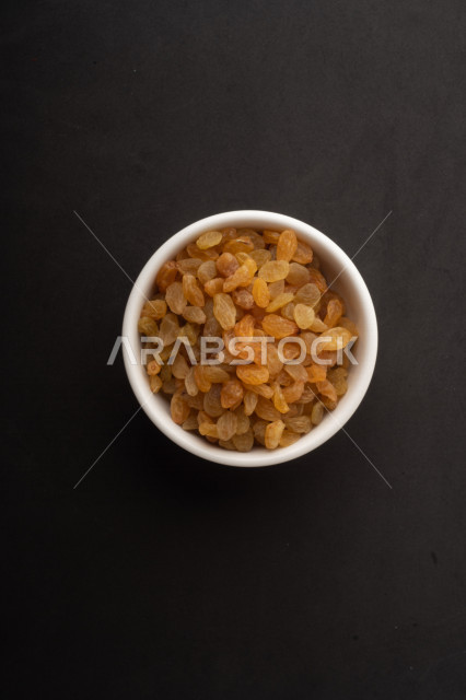 raisins (dried grapes) a kind of dried fruit, close-up of dried raisins, healthy and delicious dried fruits, healthy food ingredient, black background