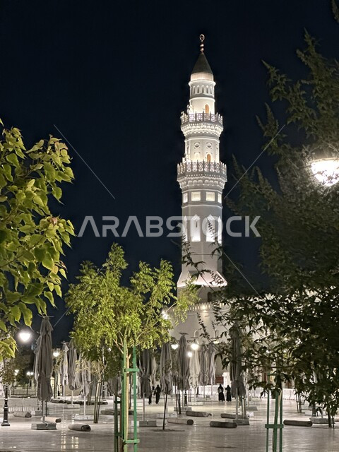Minarets and domes illuminated at night, landmarks and holy religious places in the Kingdom of Saudi Arabia, calling Muslims to perform prayers and draw closer to God Almighty, Quba Mosque in Medina, Islamic architectural art and decorations in the modern style