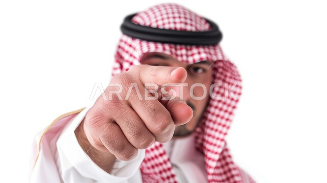 Expressions of identification and emphasis, pointing to something, portrait of a Saudi Gulf Arab man wearing a thobe and wearing a shemagh, pointing with his index finger to choose, white background