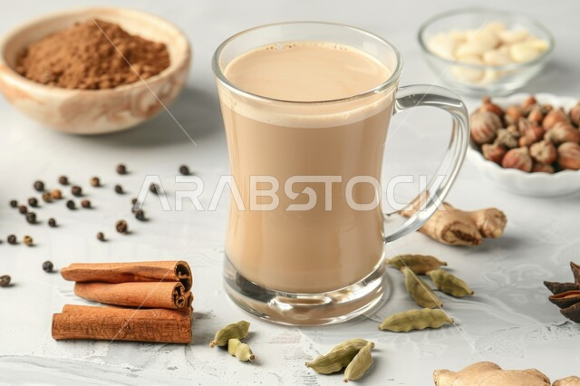 Hospitality and welcome, enjoying hot drinks, close-up of a cup of black tea and milk mix with ginger and other spices, masala chai with cinnamon sticks, health benefits